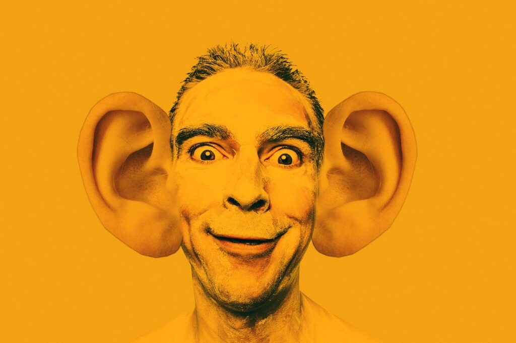 A man with big ears trying to hear and be heard.